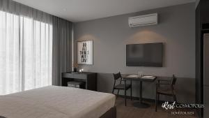 a bedroom with a bed and a desk and a tv at iRest COSMOPOLIS Vinh Yen in Yen