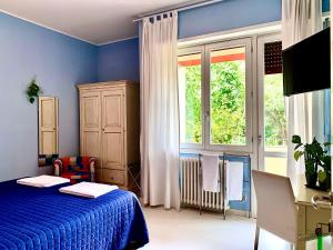 a blue bedroom with a bed and a window at Casa Italia in Verona