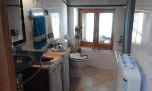 a bathroom with a sink and a toilet and a window at CASA BONITA in Morella