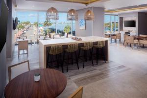 a kitchen and dining room with a view of the ocean at Hyatt Place Aruba Airport in Oranjestad