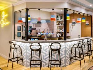 a bar in a restaurant with stools at ibis Styles Bournemouth in Bournemouth