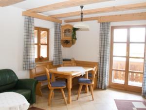 a living room with a table and chairs and a couch at Schwaigerhof Rottau in Rottau