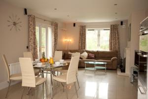 a living room with a table and chairs and a couch at Berehaven Lodge in Castletownbere