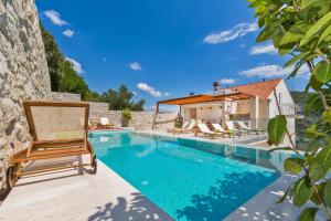 a villa with a swimming pool and a house at Villa Boban Deluxe in Dubrovnik