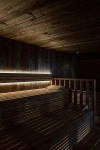 an empty room with a wooden floor and wooden walls at Sporthotel Igls in Innsbruck
