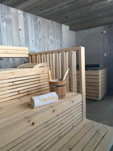 a sauna with a bucket on a wooden bench at Sporthotel Igls in Innsbruck