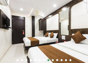 Postel nebo postele na pokoji v ubytování Hotel Guestinn Residency