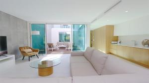 un salon avec un canapé blanc et une table dans l'établissement Villa Terese-CleverDetails, Central Vilamoura, Sleeps 6, luxury, walking distance, à Vilamoura