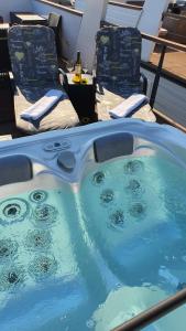 a hot tub on the deck of a boat at Floating Sea House SONČEK in Portorož