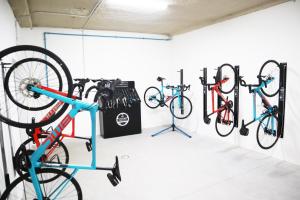 a room with three bikes hanging on a wall at Gara Suites Golf & Spa in Playa de las Americas