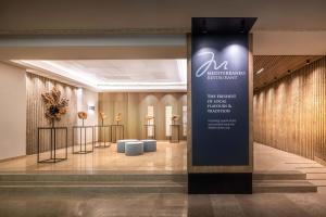 a lobby with a sign in the middle of a building at Valamar Diamant Hotel in Poreč