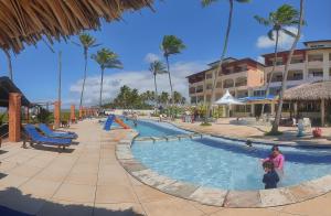 a woman and child in a swimming pool at a resort at Costa Brava Praia Hotel in Lucena