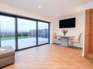 a living room with a table and a television at ViewLangho in Blackburn