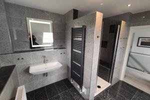 a bathroom with a sink and a mirror at Ferienhaus Blue Pearl in Scharbeutz