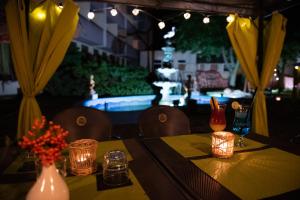 a table with a yellow table cloth and candles on it at Perła in Oleśnica