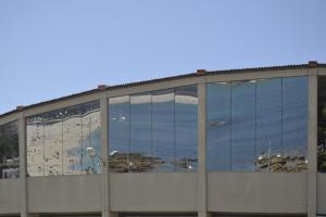 a building with glass windows on the side of it at Hotel Brisa in A Coruña