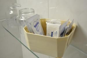 a container of toothbrushes on a glass table at Hotel Brisa in A Coruña