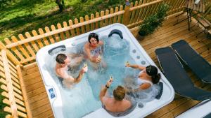 a group of people playing in a hot tub at Connyhaus St Oswald ob Eibiswald in Sankt Oswald ob Eibiswald