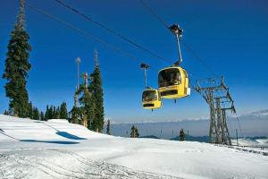 a ski lift going over a snow covered slope at Young Minar Group of HouseBoats in Srinagar