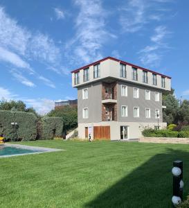 a large apartment building with a large yard at Istanbul Park Hotel in Tuzla
