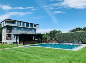 a large building with a swimming pool in a yard at Istanbul Park Hotel in Tuzla
