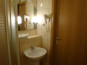 a bathroom with a sink and a mirror at Hotel Wieniawa in Wrocław