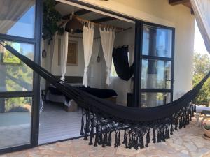 a hammock on the porch of a house at Villa Dolina Hvar in Hvar