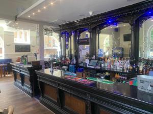 a bar in a pub with a lot of alcohol at Royal Hotel Sheerness in Sheerness