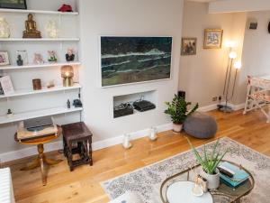 a living room with a table and a couch at Pass the Keys Immaculate flat with roof terrace in North London in London