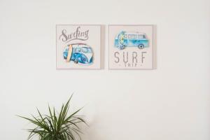 two posters on a wall with two pictures of a van at OLA Guesthouse in Esmoriz