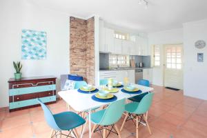 a kitchen and dining room with a white table and chairs at OLA Guesthouse in Esmoriz +35 photos