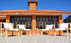 a group of chairs and a table on a patio at OLA Guesthouse in Esmoriz