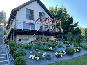 a house with a garden in front of it at Wakacyjny Hartowiec 2 in Grodziczno