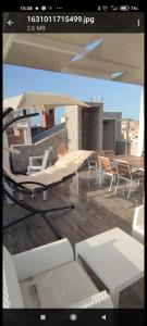 a view of a living room with chairs and tables at Centralissima Favignana in Favignana