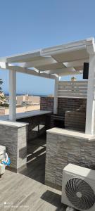 a pavilion with a picnic table and a roof at Centralissima Favignana in Favignana