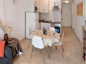 a kitchen with a table and chairs in a room at Beautiful Apartment in Palm-Mar