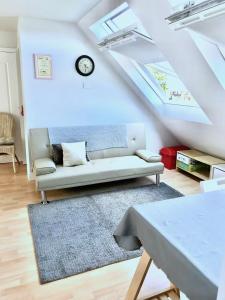 a living room with a couch and a clock on the ceiling at Fox View Guesthouse in Bristol