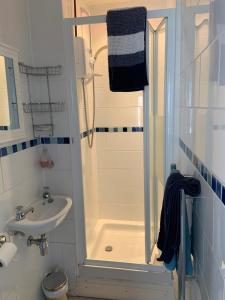 a small bathroom with a shower and a sink at Seven Bays Stays in Saint Merryn