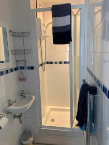 a small bathroom with a shower and a sink at Seven Bays Stays in St Merryn +12 photos