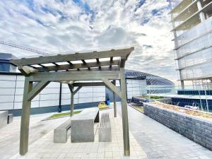 a wooden bench sitting on top of a building at City Home Finland Arena Suite - Perfect location with City View in Tampere