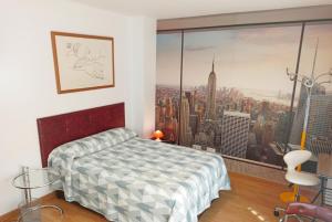 une chambre avec un lit et une grande fenêtre dans l'établissement Armengual Centro, à Malaga