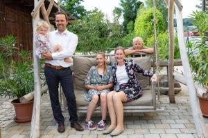 a group of people sitting on a swing at Ringhotel sKreuz in Steinheim am Albuch