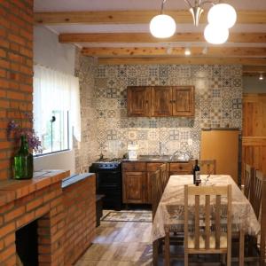 a kitchen with a table and a brick wall at Casa Goethe - Bio Cult in Campo Alegre