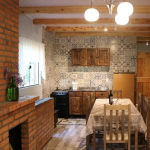 a kitchen with a table and a brick wall at Casa Goethe - Bio Cult in Campo Alegre +25 photos
