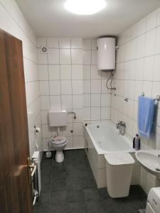 Un baño con bañera, inodoro y lavabo. en Milgor, en Banja Luka 15 fotos más