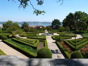 a view of a garden with a fountain and bushes at The 8 - Downtown Suites in Lisbon