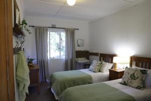 En eller flere senge i et værelse på Doornfontein Guest Farm