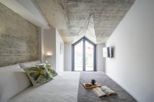 a room with a bed and a large window at Malaga a Tu Ritmo! Edificio muy tranquilo y moderno! in Málaga