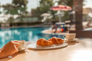 two cups of coffee and two pastries on a table at Residence Camping Atlantide in Monopoli