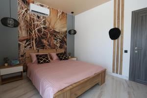a bedroom with a bed with a painting on the wall at Villa Bonapart in Zatoka +93 photos